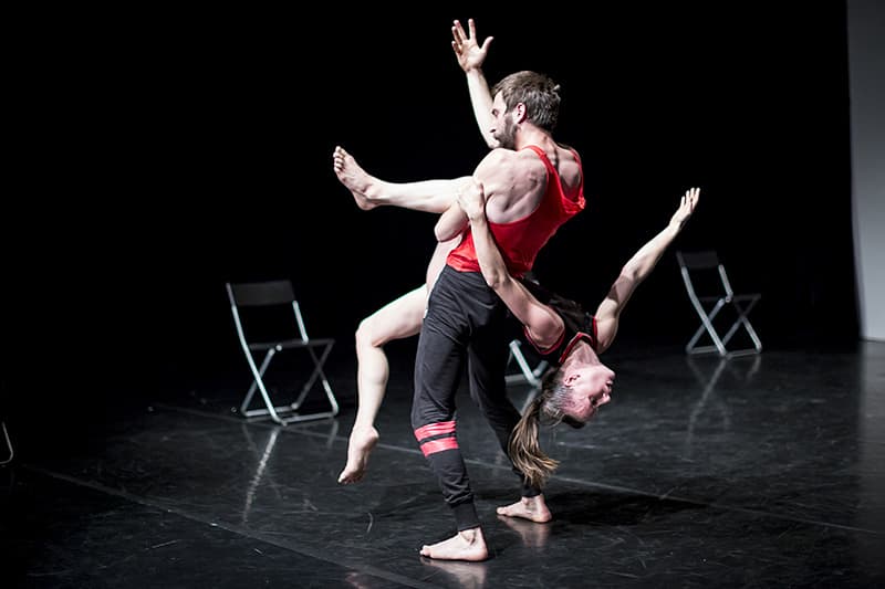 Contemporary dancers performing on stage.