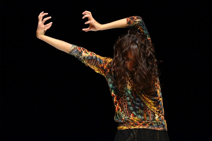 Woman dancing with expressive arm movements