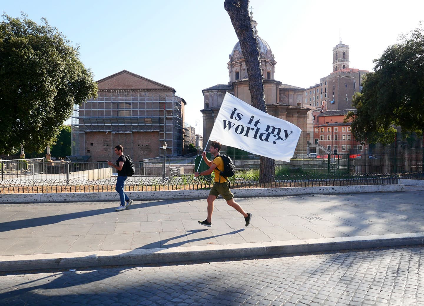 Person running with 'Is it my world?' banner