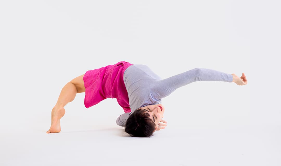 Dancer Mathilde Gilhet in a corkscrew position on the floor