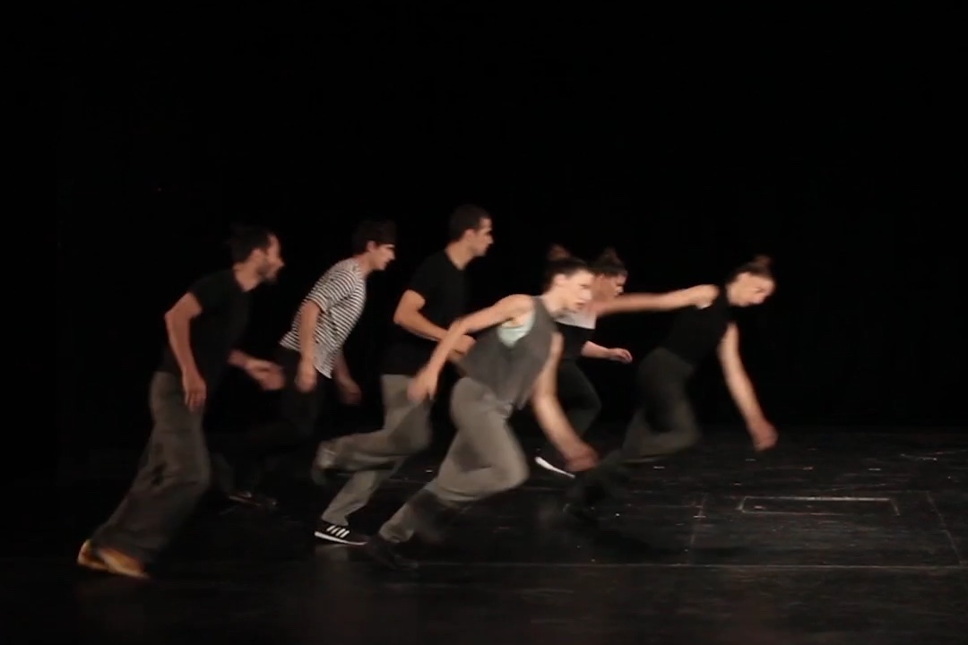 Group of dancers perform dynamic stage movement