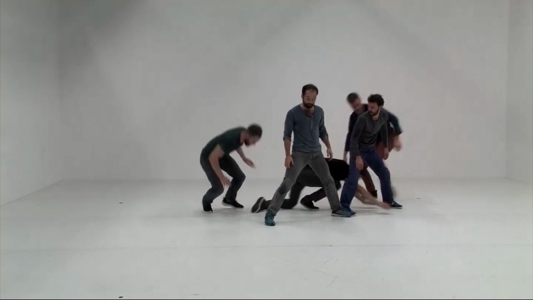 Group performing contemporary dance in studio.