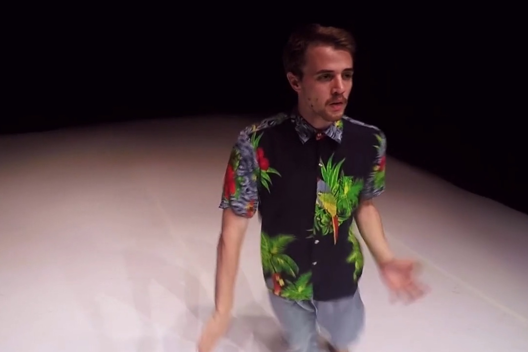 Man in tropical shirt dancing on stage