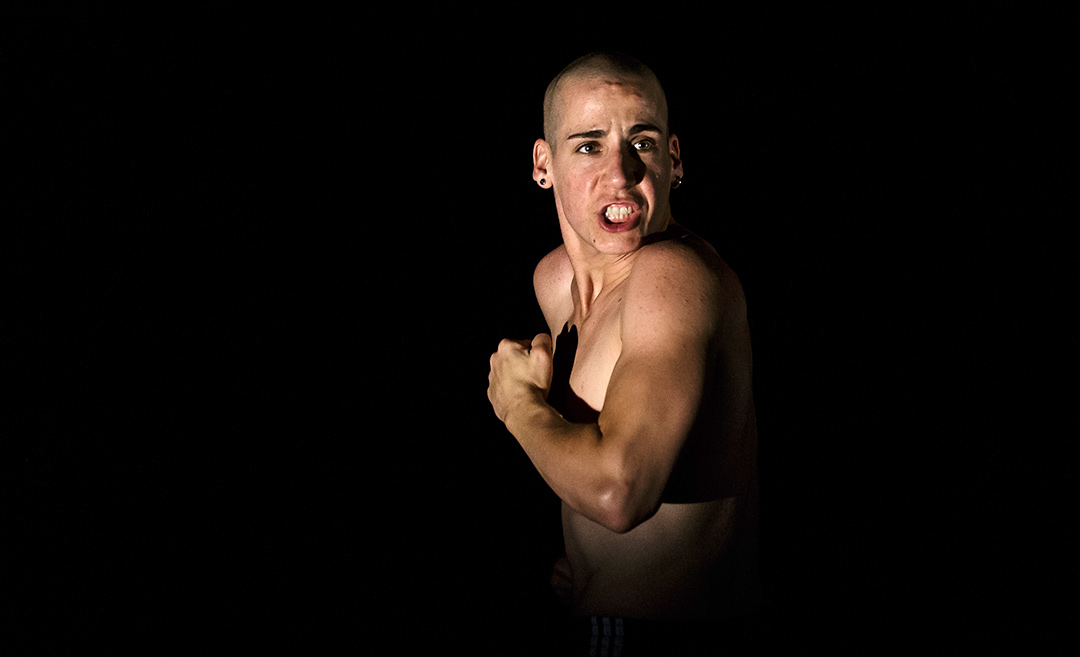 Person posing fiercely in dramatic lighting