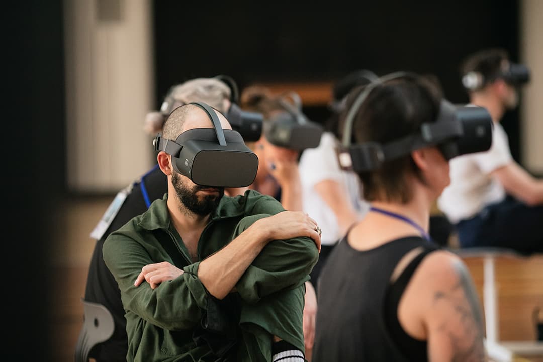 Group using virtual reality headsets in workshop.