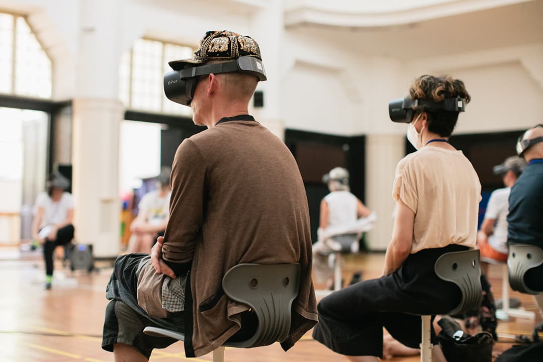 People using virtual reality headsets in a studio.