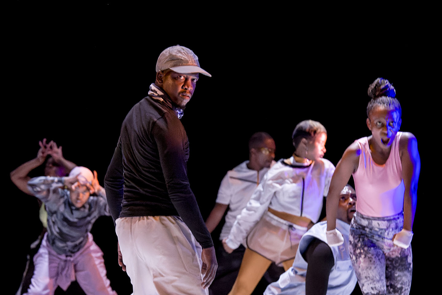 Dancers perform energetically on stage.