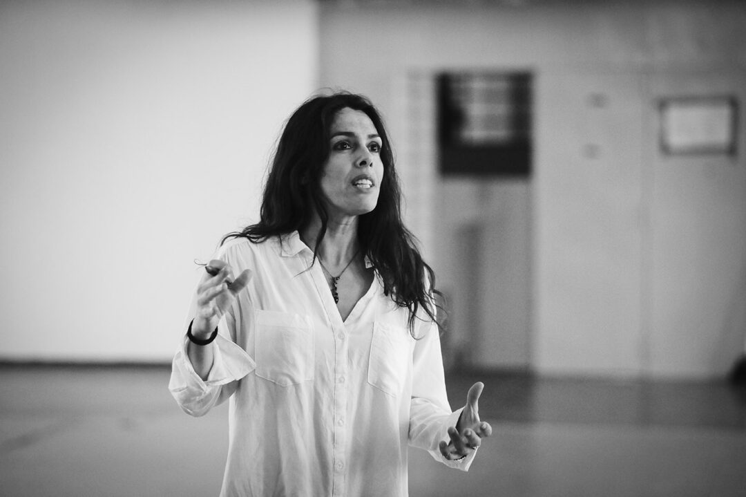 Woman speaking passionately during presentation.