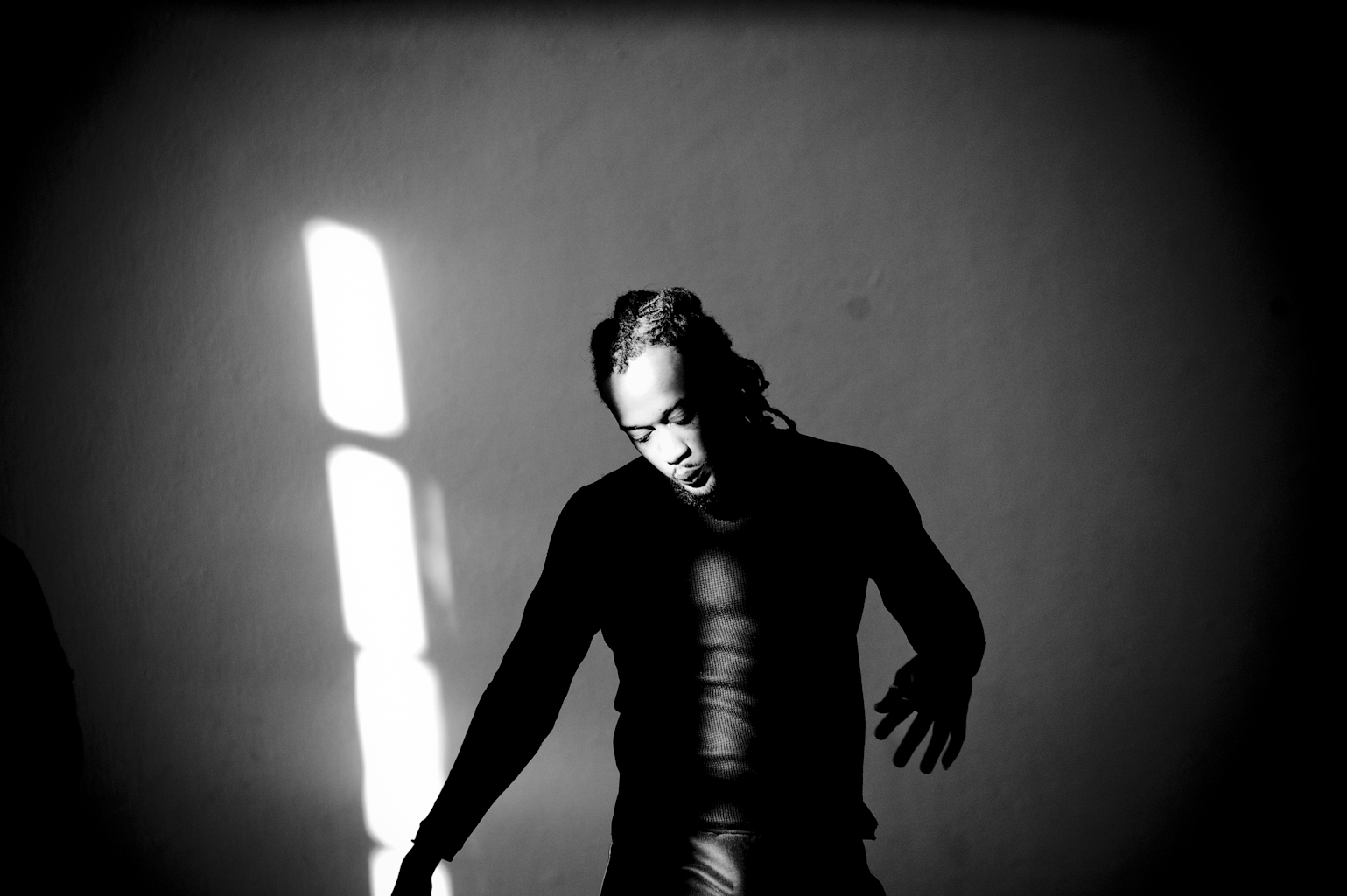 Person in shadowy light, artistic black and white photo.