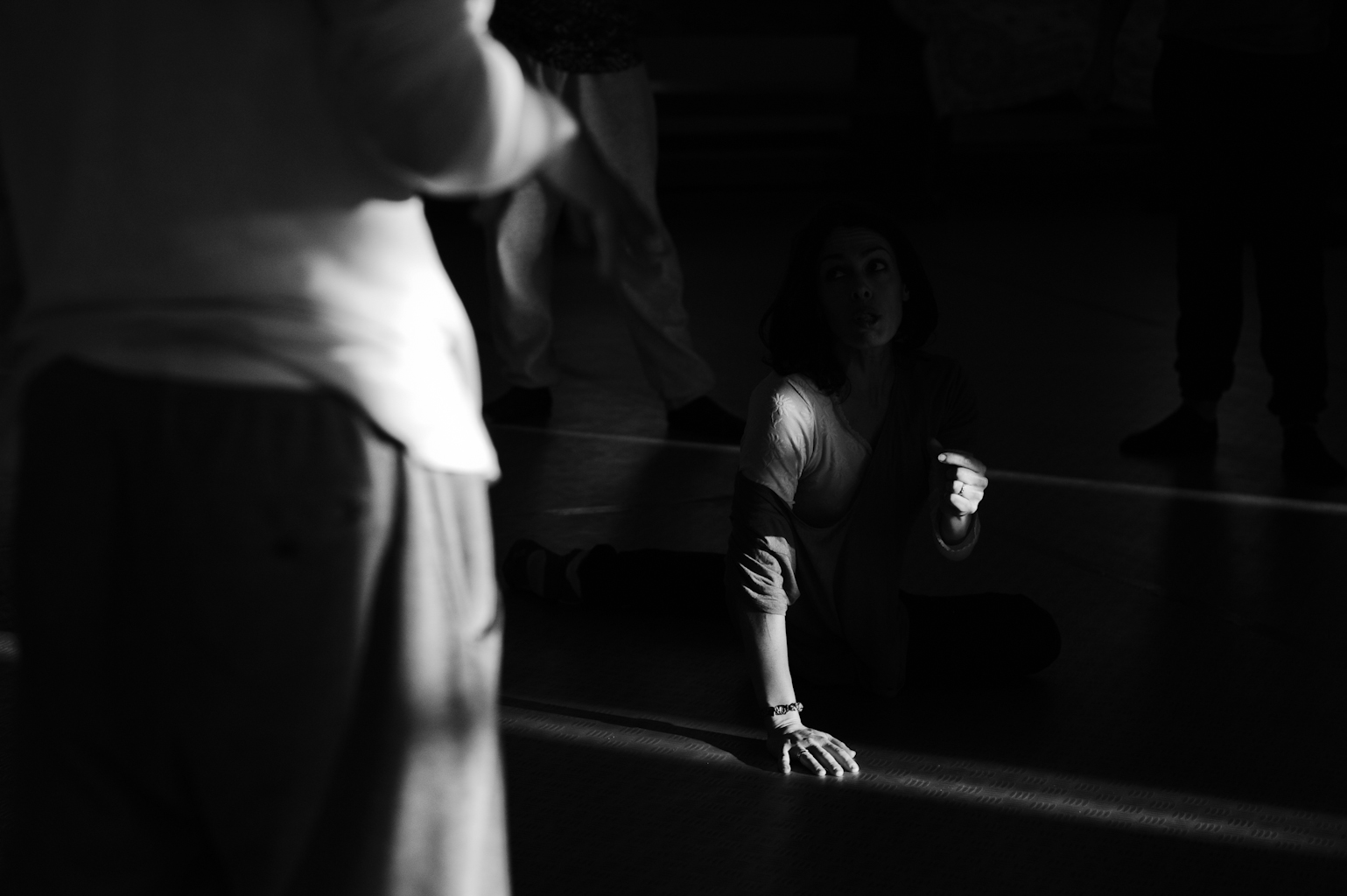 Person kneeling on dimly lit floor