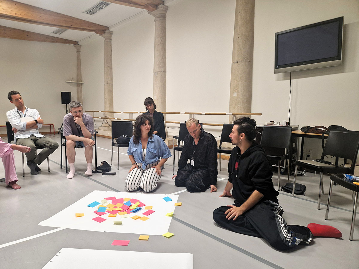People discussing ideas with colourful sticky notes.