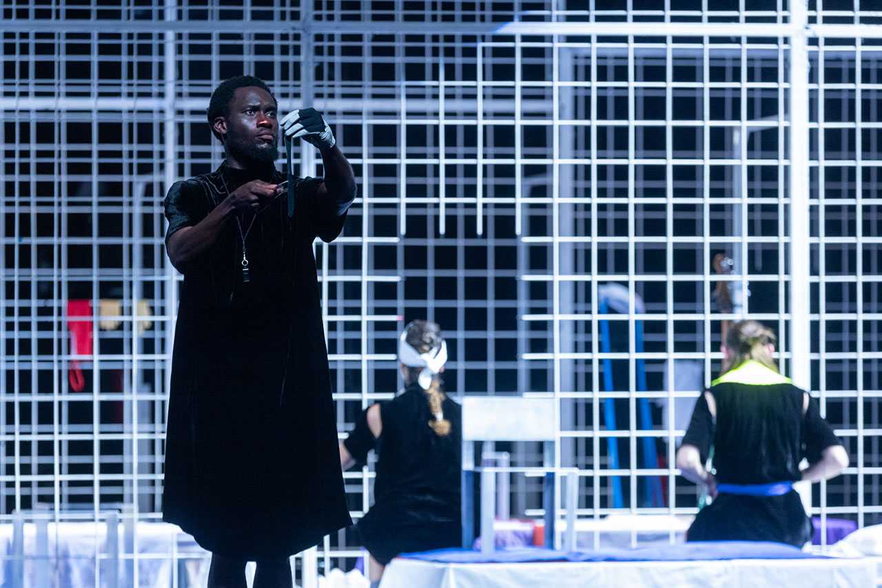 Actors performing a play on modern stage set