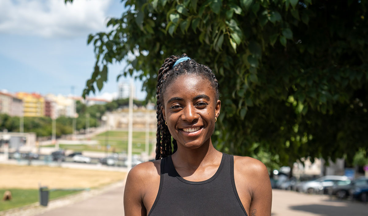 Smiling woman in sportswear outdoors on sunny day