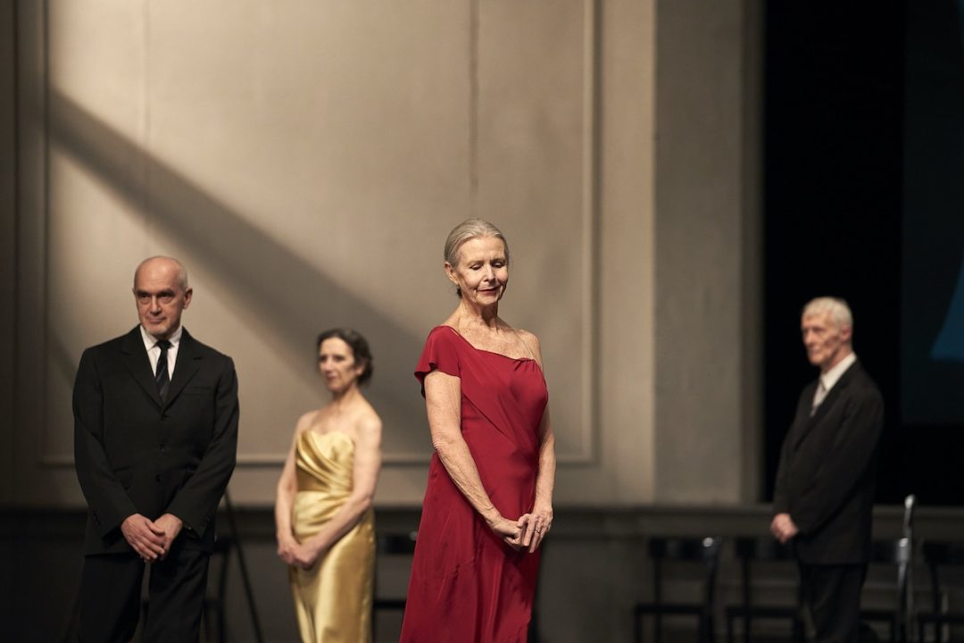 Elegantly dressed people standing on stage at ceremony