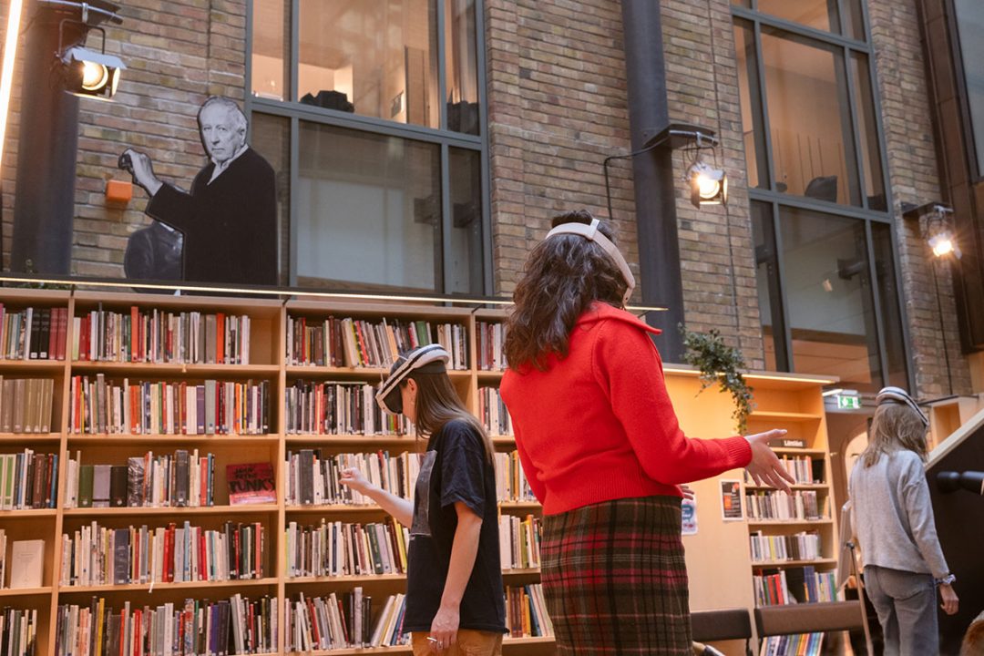 People wearing headsets in modern library space