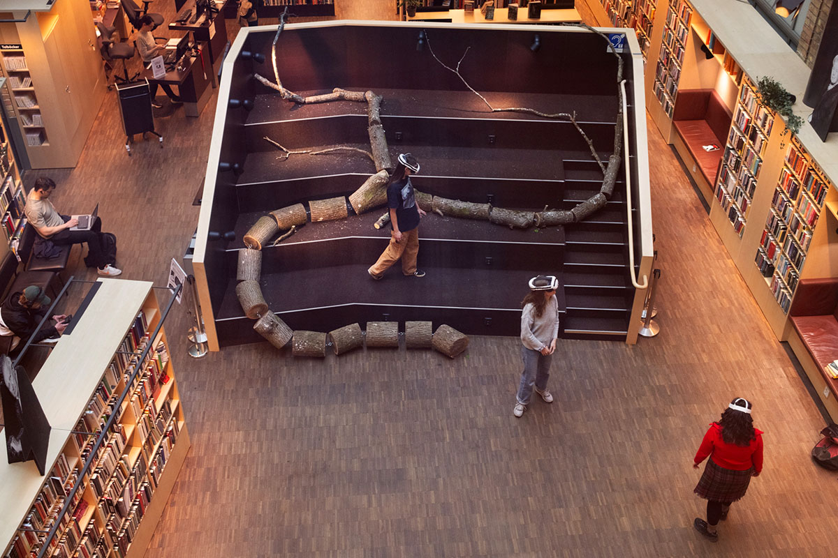 People using VR headsets in library installation