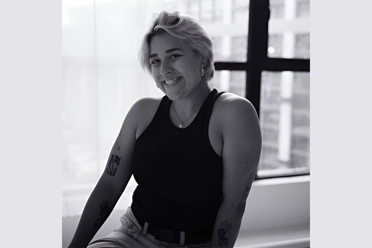black and white portrait of a smiling woman against a window