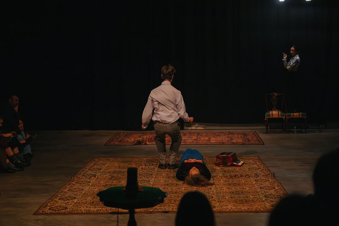 Theatre performance with man kneeling beside woman