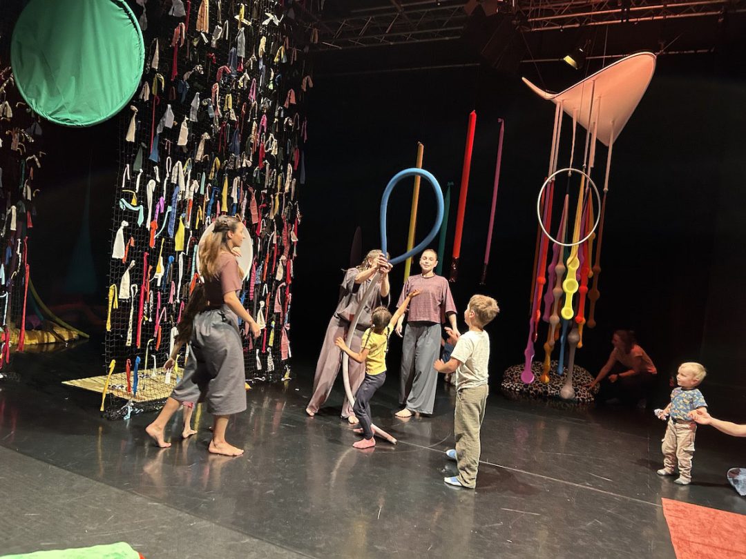 Children and adults playing in colourful art installation