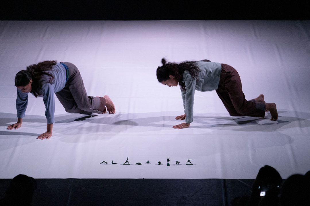 Two women crawling in contemporary dance performance