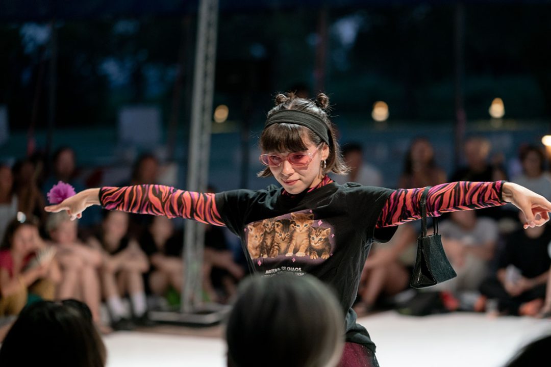 Model wearing graphic T-shirt on fashion runway